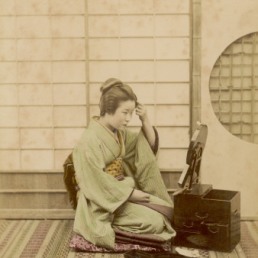 a-geisha-adjusts-her-elaborate-hair-style